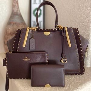 Coach Dreamer 36 set in Oxblood with Rivets